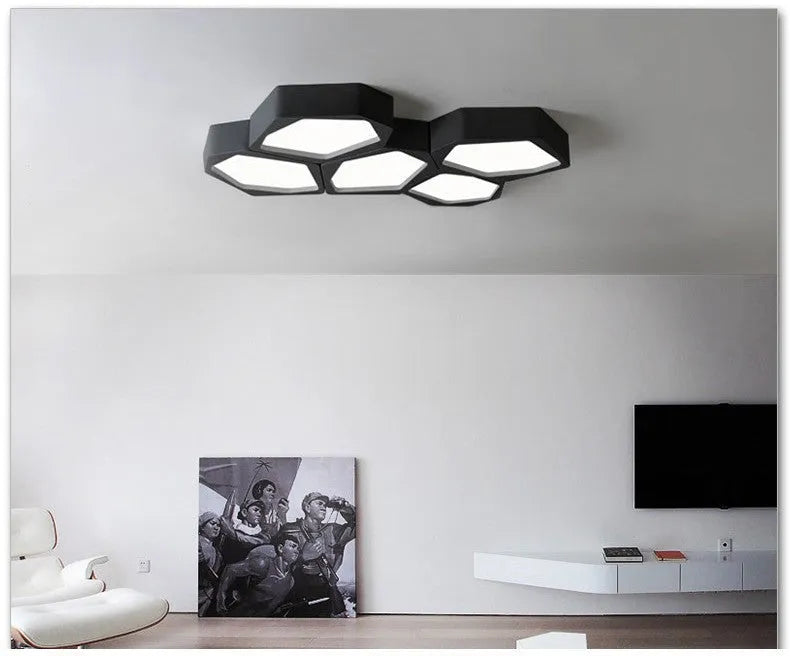 Modern geometric-shaped iron wall light with remote control on a living room wall.