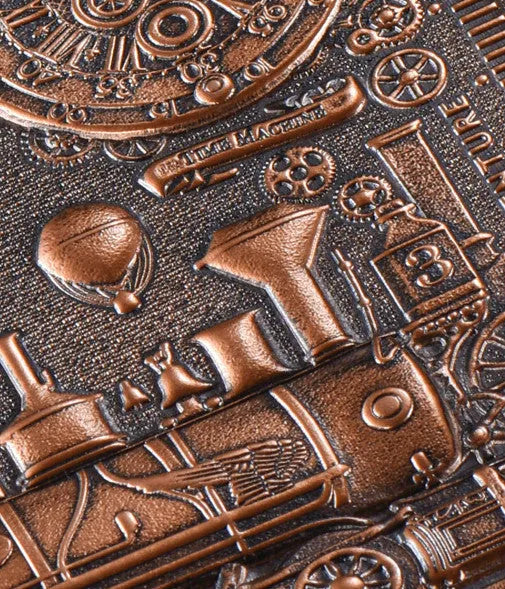 European retro notepad with embossed leather cover in bronze, open on a page of handwritten notes.