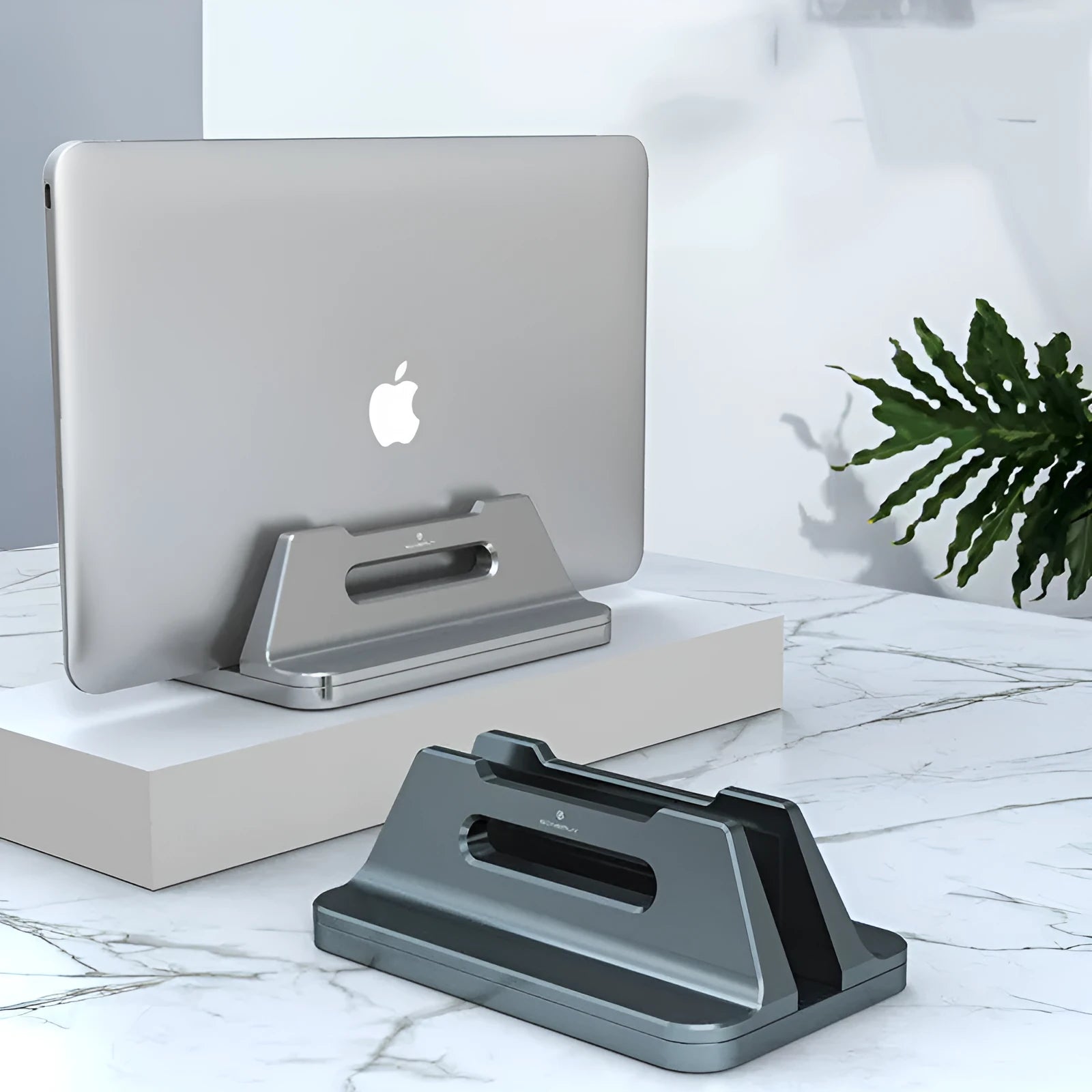Silver aluminium alloy vertical notebook storage bracket on desk holding a laptop upright