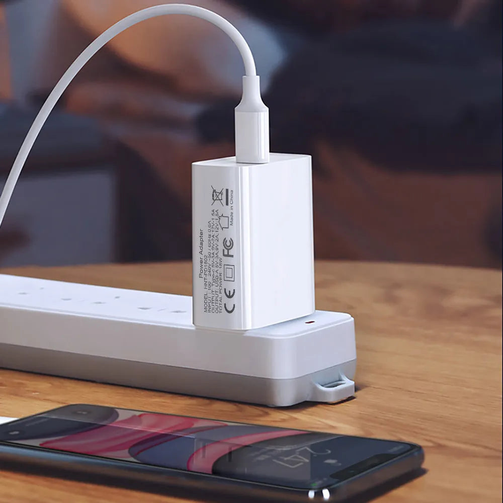 White 18W fast charger with dual USB ports and international plug options