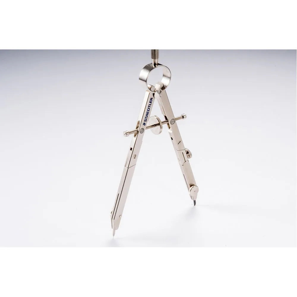 STAEDTLER steel car drafting compass with extended telescopic rod on technical drawing paper.