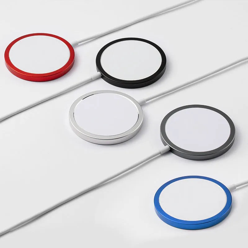Silver metallic MagSafe-compatible magnetic wireless charger for iPhone on a wooden desk.