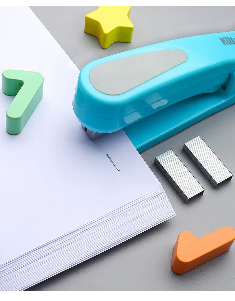 Black 360-degree rotatable stapler on a stack of A4 paper, showing its rotating head mechanism.