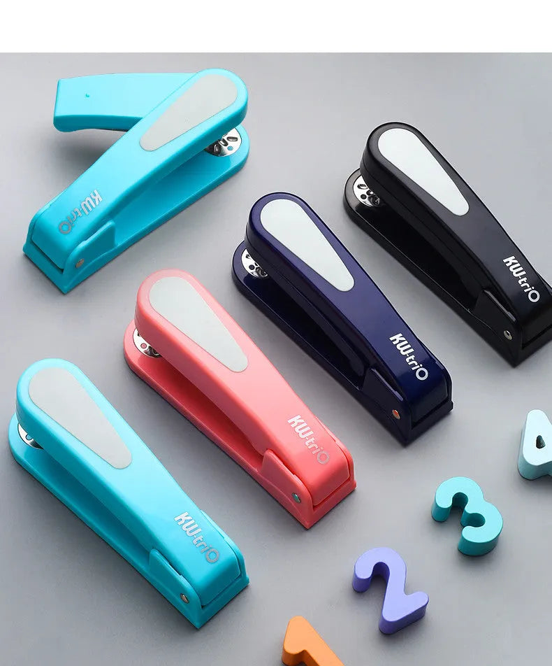 Black 360-degree rotatable stapler on a stack of A4 paper, showing its rotating head mechanism.