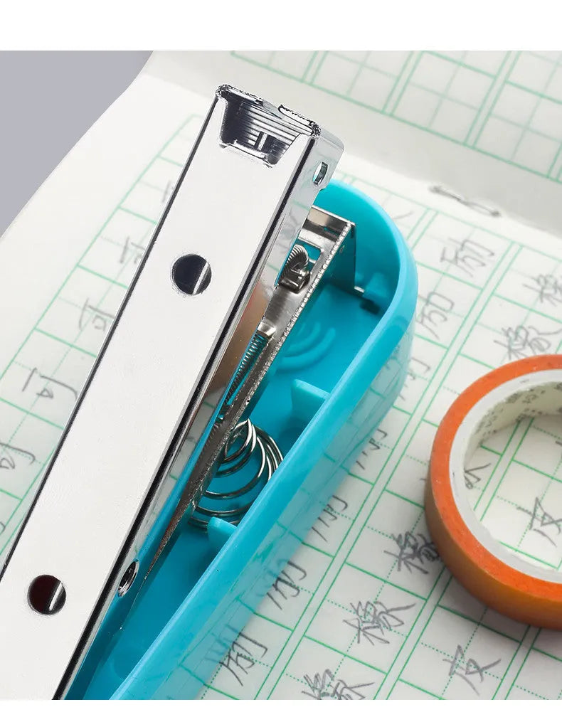 Black 360-degree rotatable stapler on a stack of A4 paper, showing its rotating head mechanism.