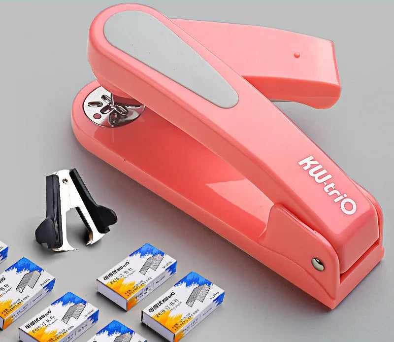Black 360-degree rotatable stapler on a stack of A4 paper, showing its rotating head mechanism.