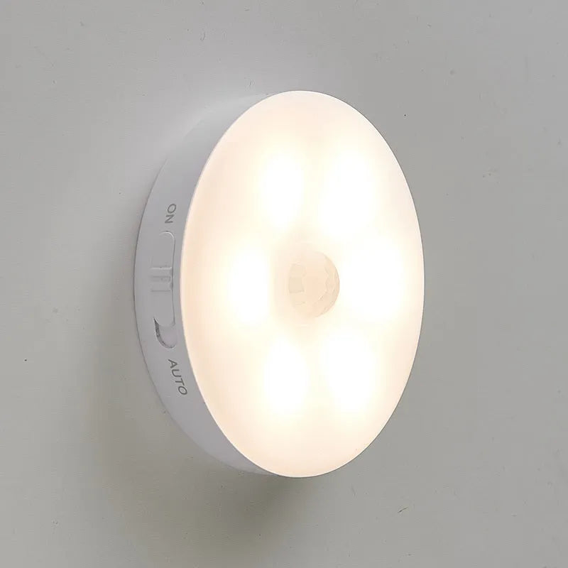 Two wireless motion sensor LED lights mounted inside a wooden cabinet.