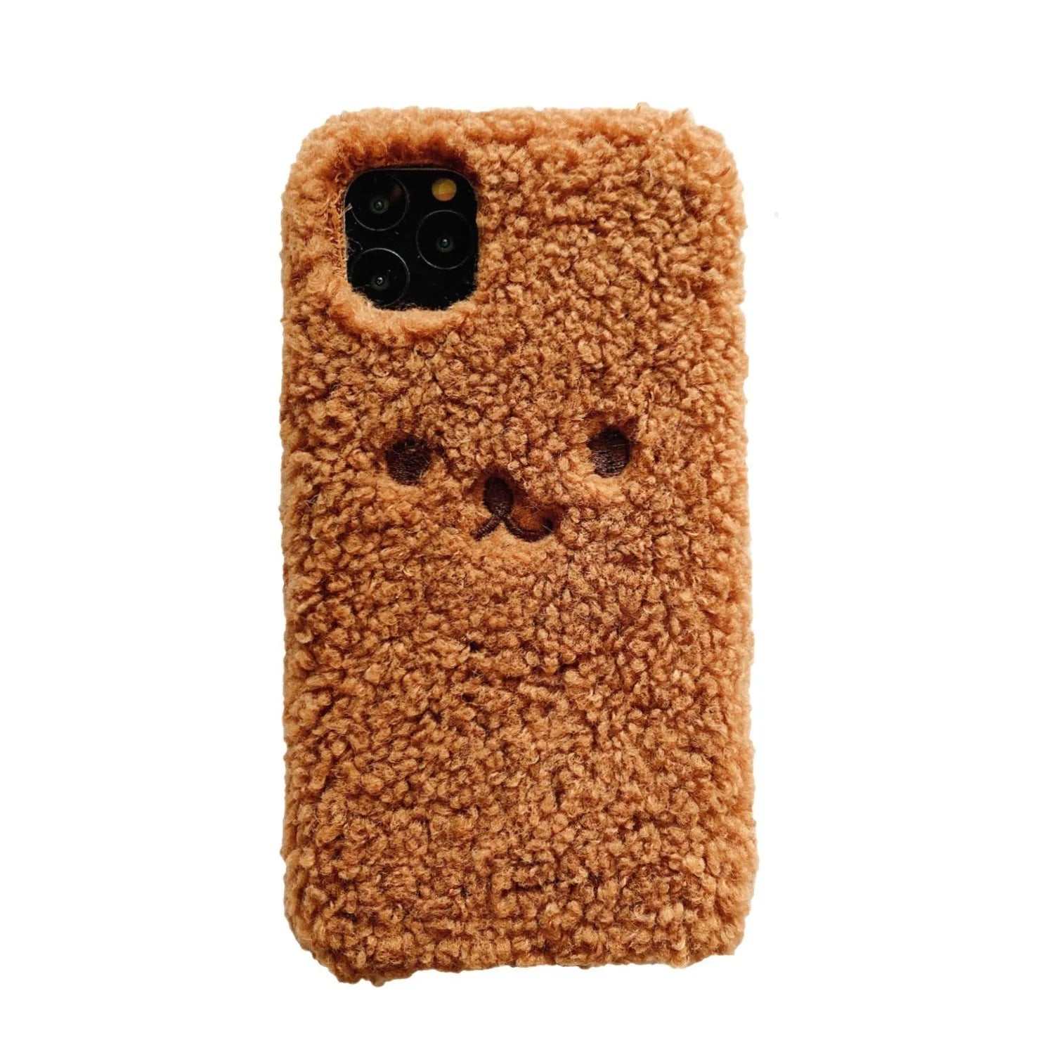 Brown embroidered plush cartoon bear face on a clear TPU iPhone 11 case, showing raised edges.