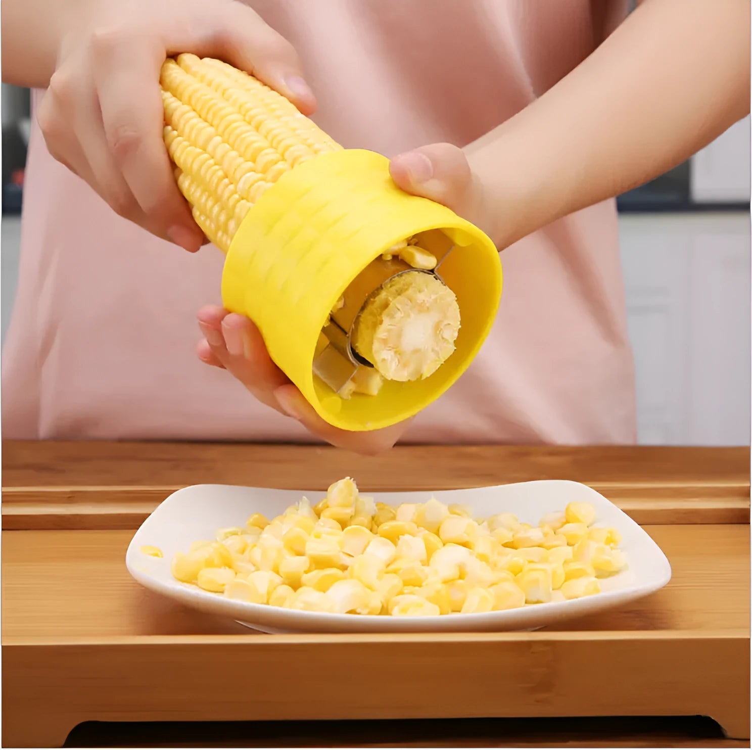 Yellow manual corn grinder thresher with corn-shaped design and stainless steel gear.