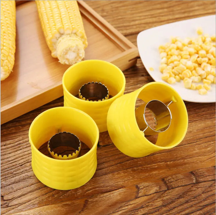 Yellow manual corn grinder thresher with corn-shaped plastic body and stainless steel peeling gear