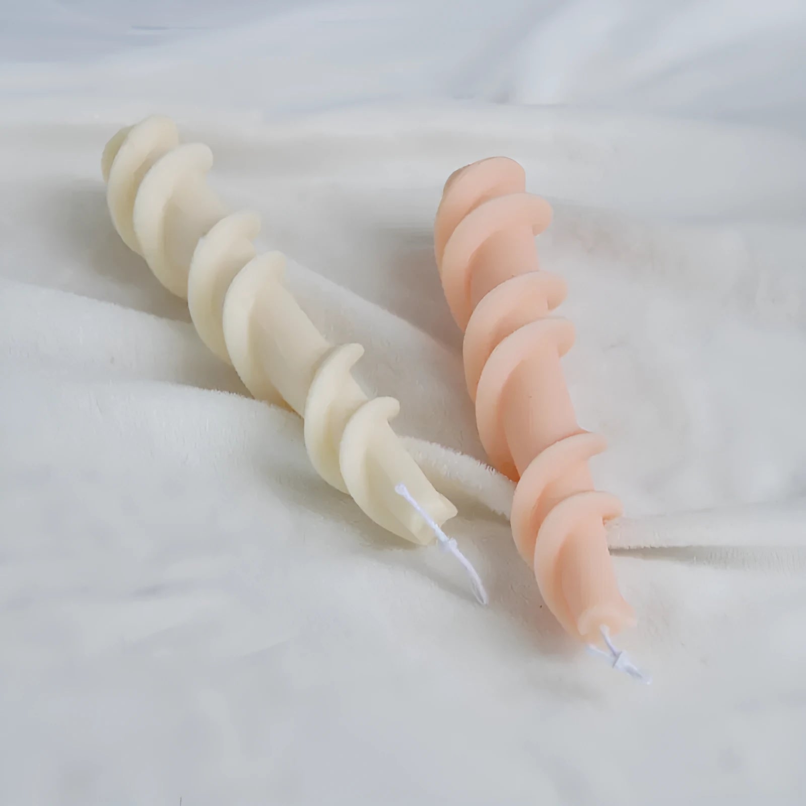 Handmade spiral lace rod silicone candle mould for creating textured decorative candles.