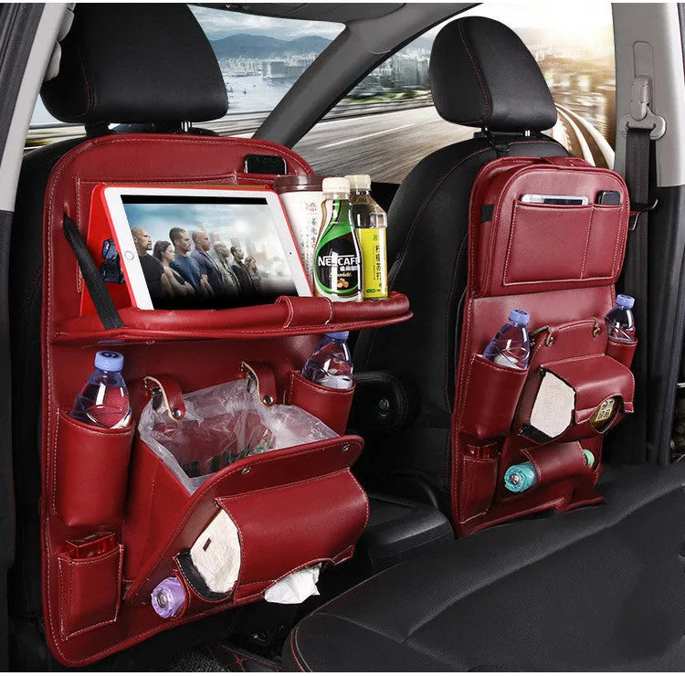 Black PU leather car seat back hanging organiser with storage pockets and a removable bin attached to a car headrest.