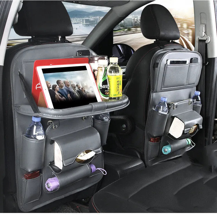 Black PU leather car seat back hanging organiser with storage pockets and a removable bin attached to a car headrest.