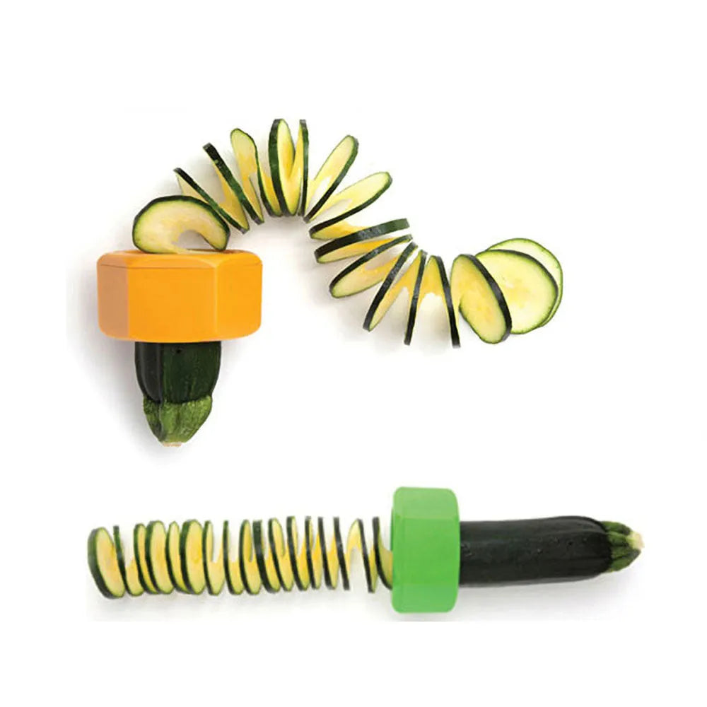 Yellow and green plastic spiral vegetable cutter for slicing cucumbers on a kitchen worktop.