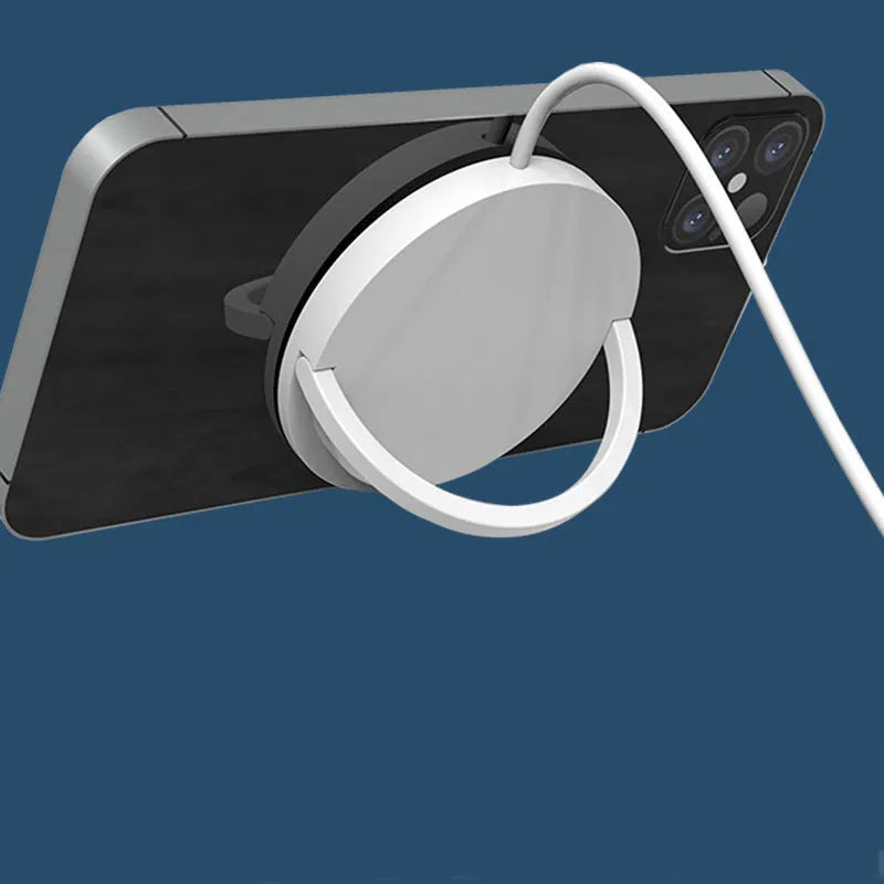Black magnetic wireless charging bracket for mobile phones mounted on a car dashboard.