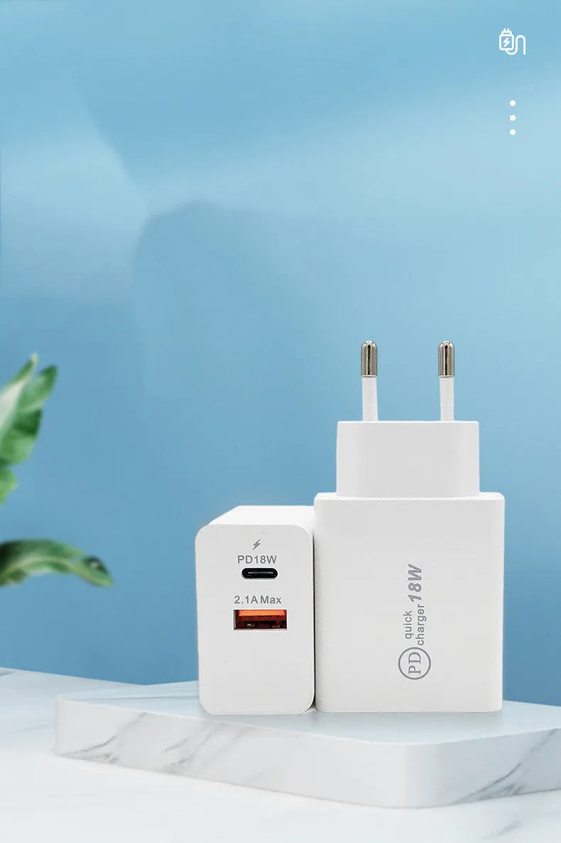 Compact white 18W USB-C fast wall charger with UK plug on a wooden table