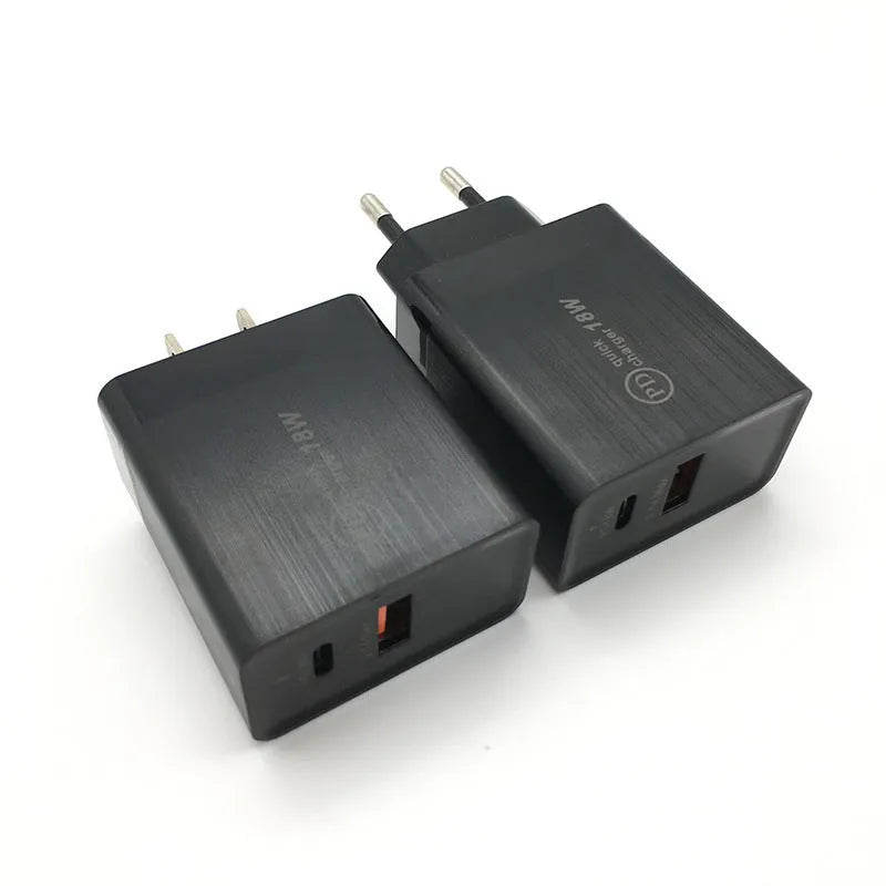 Compact white 18W USB-C fast wall charger with UK plug on a wooden table