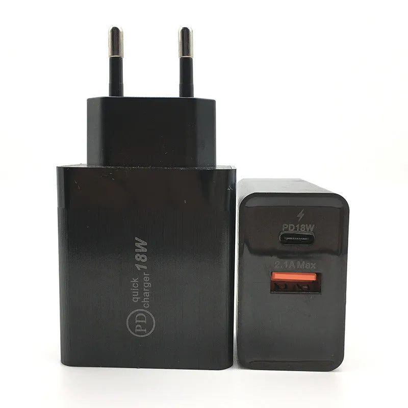 Compact white 18W USB-C fast wall charger with UK plug on a wooden table