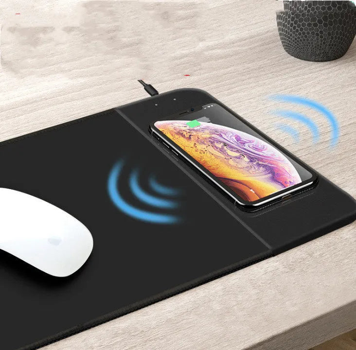 Cartoon-style wireless charging mouse pad with glowing RGB lights on a desk