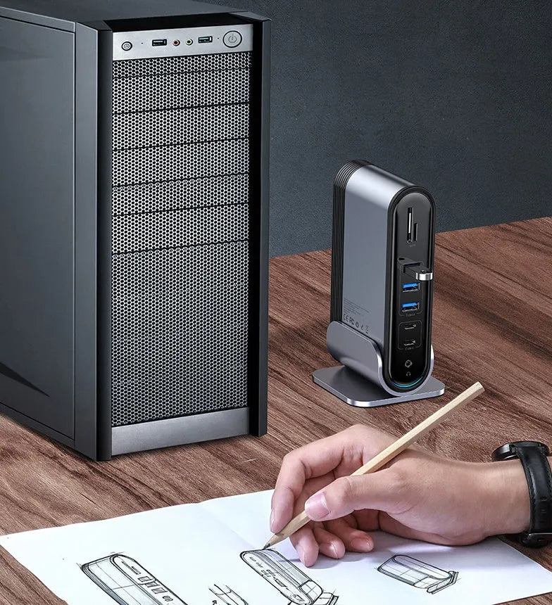 Deep space grey 16-in-1 multi-function USB-C docking station with external power supply on a desk.