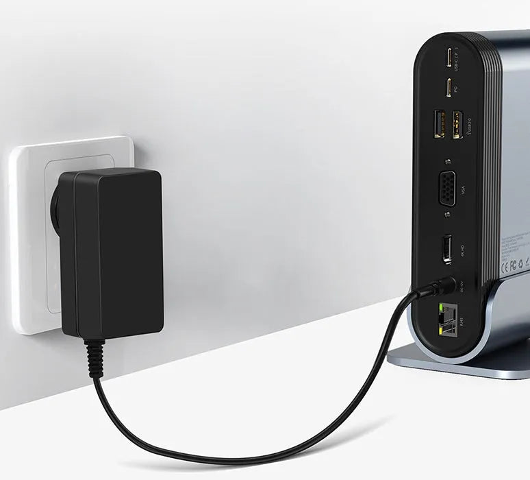 Deep space grey 16-in-1 multi-function USB-C docking station with external power supply on a desk.