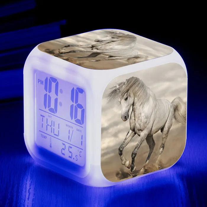 Square cartoon-style LED alarm clock showing digital time display with colour-changing illumination