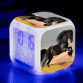 Square cartoon-style LED alarm clock showing digital time display with colour-changing illumination