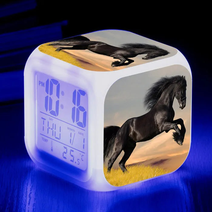 Square cartoon-style LED alarm clock showing digital time display with colour-changing illumination