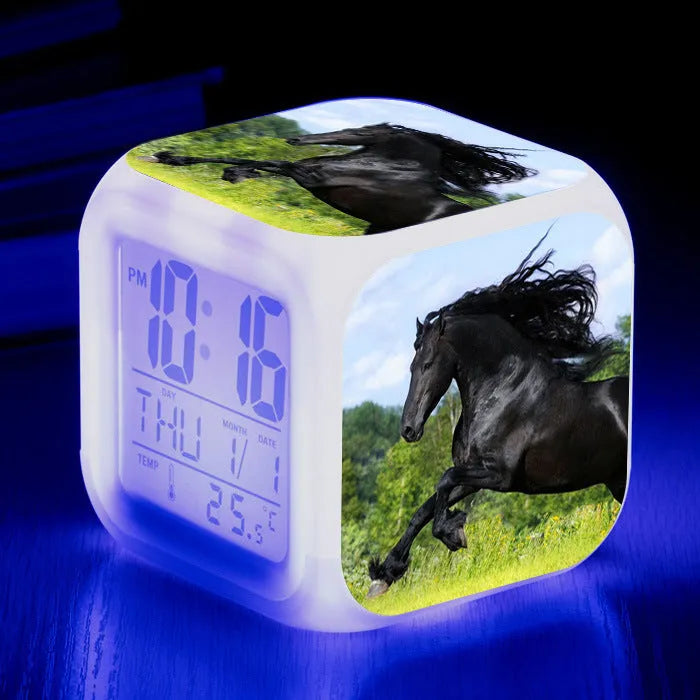 Square cartoon-style LED alarm clock showing digital time display with colour-changing illumination