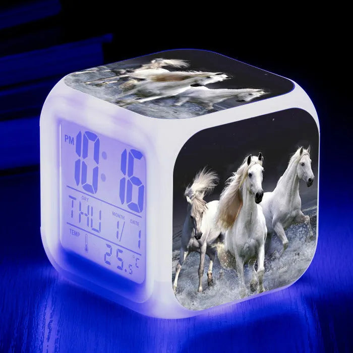 Square cartoon-style LED alarm clock showing digital time display with colour-changing illumination
