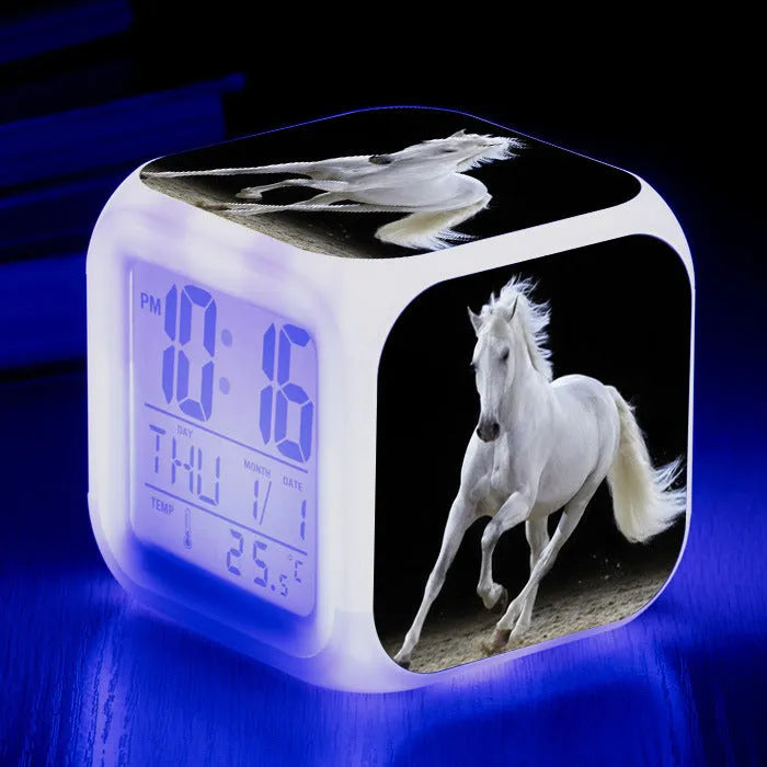 Square cartoon-style LED alarm clock showing digital time display with colour-changing illumination