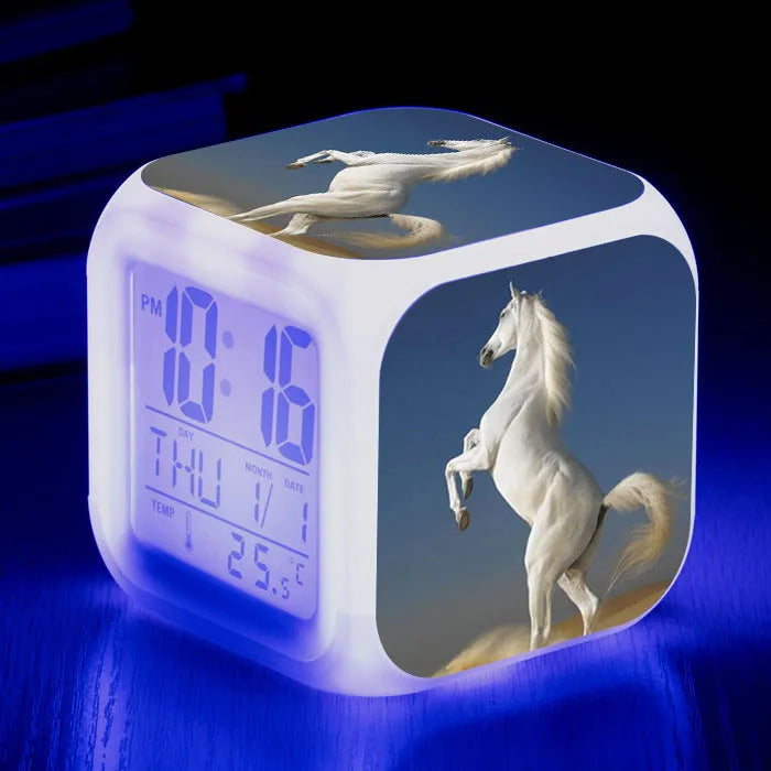 Square cartoon-style LED alarm clock showing digital time display with colour-changing illumination