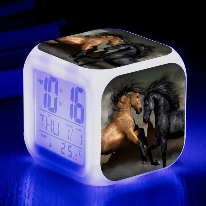 Square cartoon-style LED alarm clock showing digital time display with colour-changing illumination