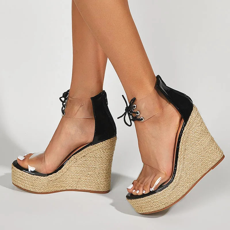 Black women's wedge sandals with hemp rope detail on a high platform heel and front tie strap.