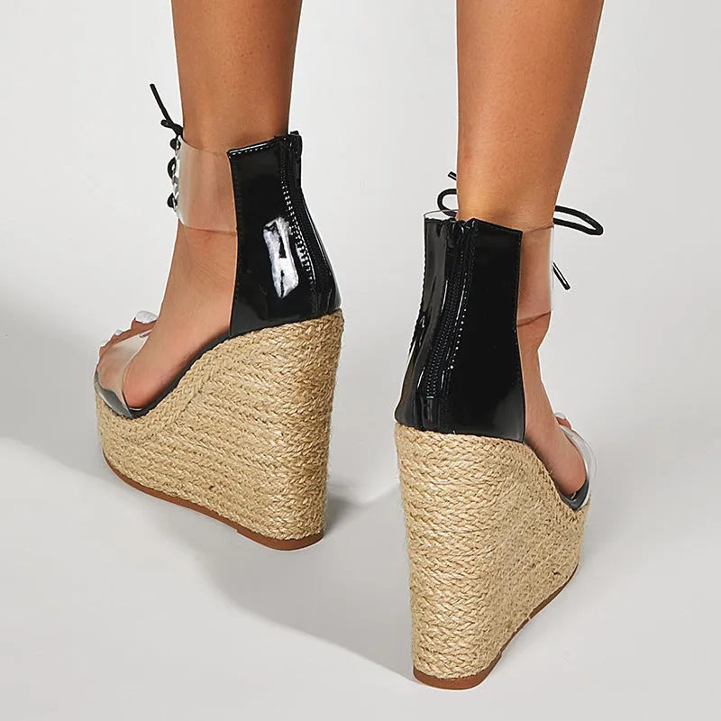 Black women's wedge sandals with hemp rope detail on a high platform heel and front tie strap.