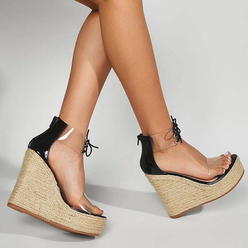 Black women's wedge sandals with hemp rope detail on a high platform heel and front tie strap.