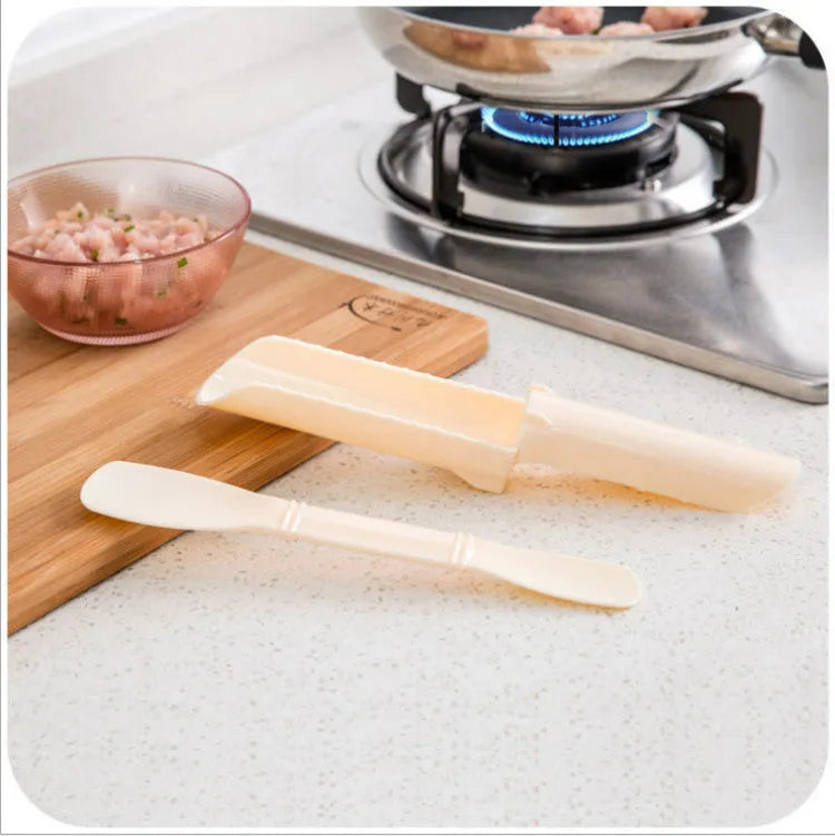 Stainless steel meatball maker with rounded scoop on a kitchen countertop
