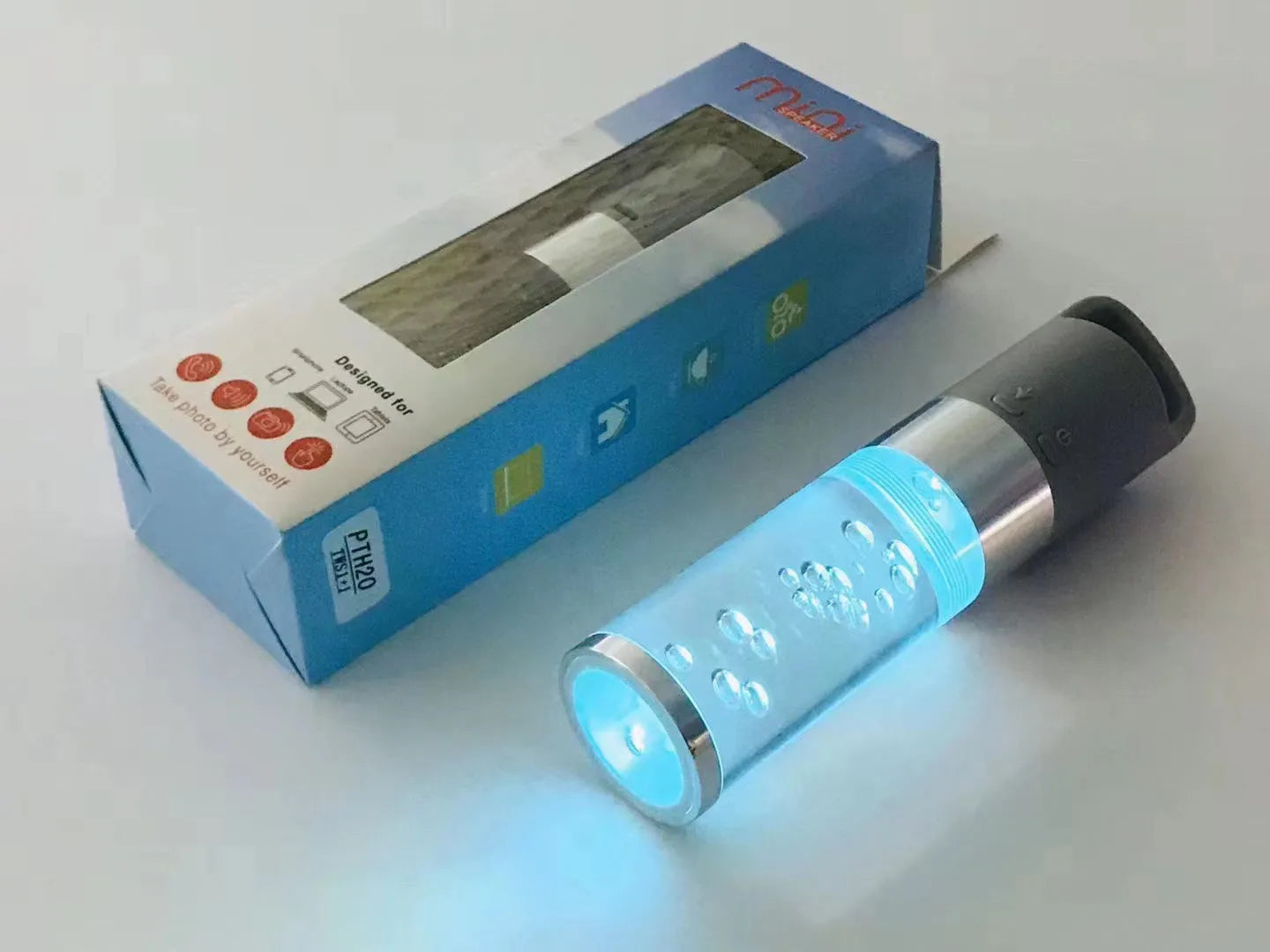Compact colourful Bluetooth speaker with glowing crystal lights, shown in pink, black, silver grey, and green colour options.