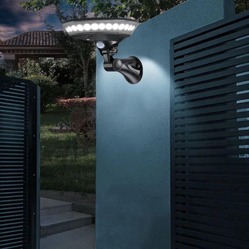 White 360-degree solar-powered security light with motion sensor, mounted on an outdoor wall.