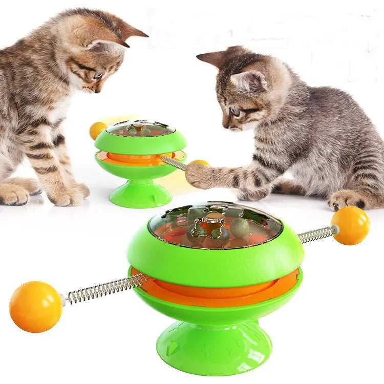 Rotatable interactive cat toy with transparent top showing catnip balls, on a suction cup base.