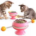 Rotatable interactive cat toy with transparent top showing catnip balls, on a suction cup base.