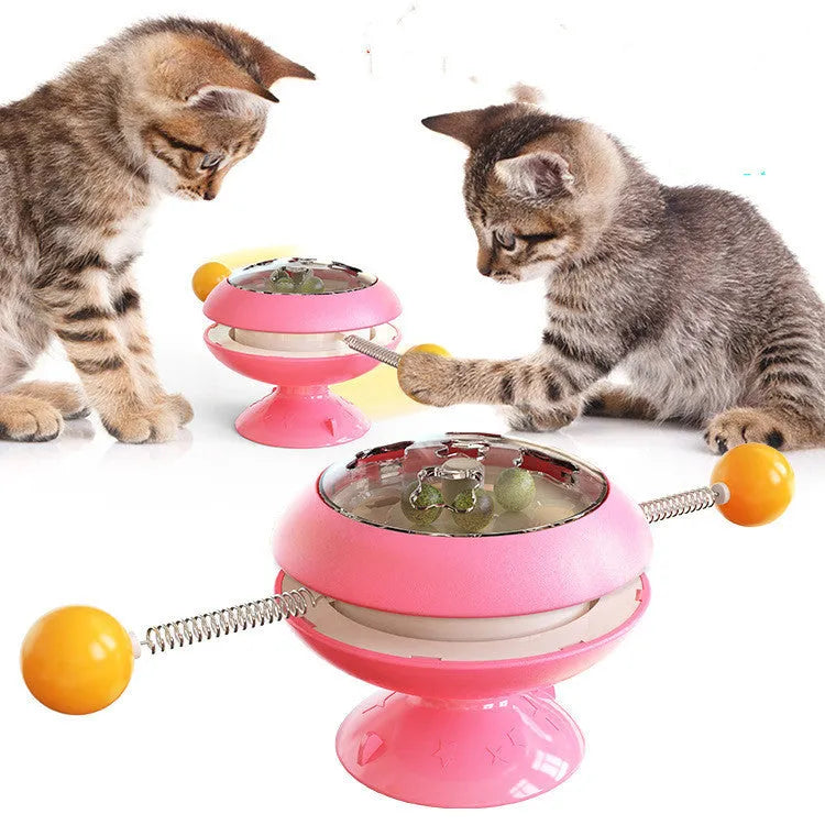 Rotatable interactive cat toy with transparent top showing catnip balls, on a suction cup base.