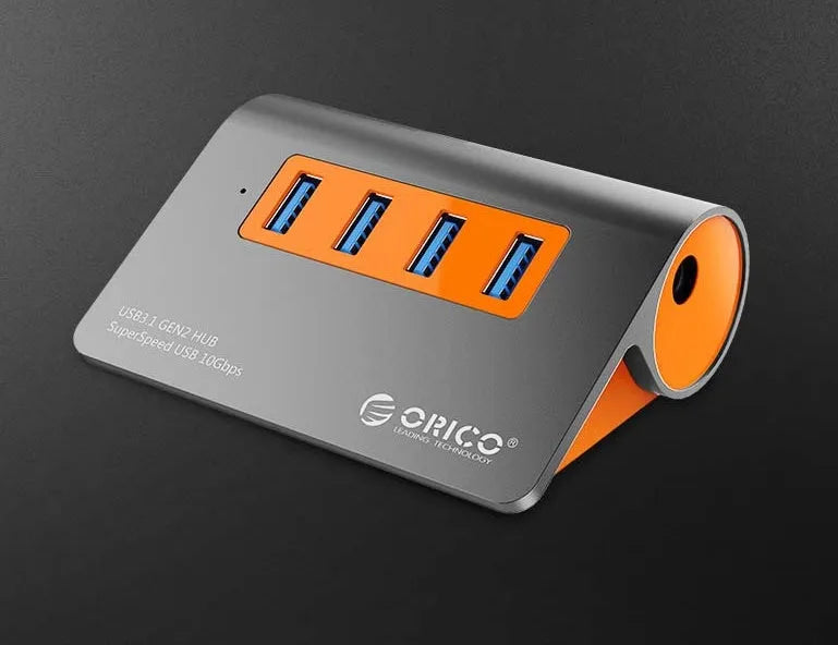 Dark grey and orange aluminium USB-C hub with four USB 3.1 ports and separate 100 cm cable