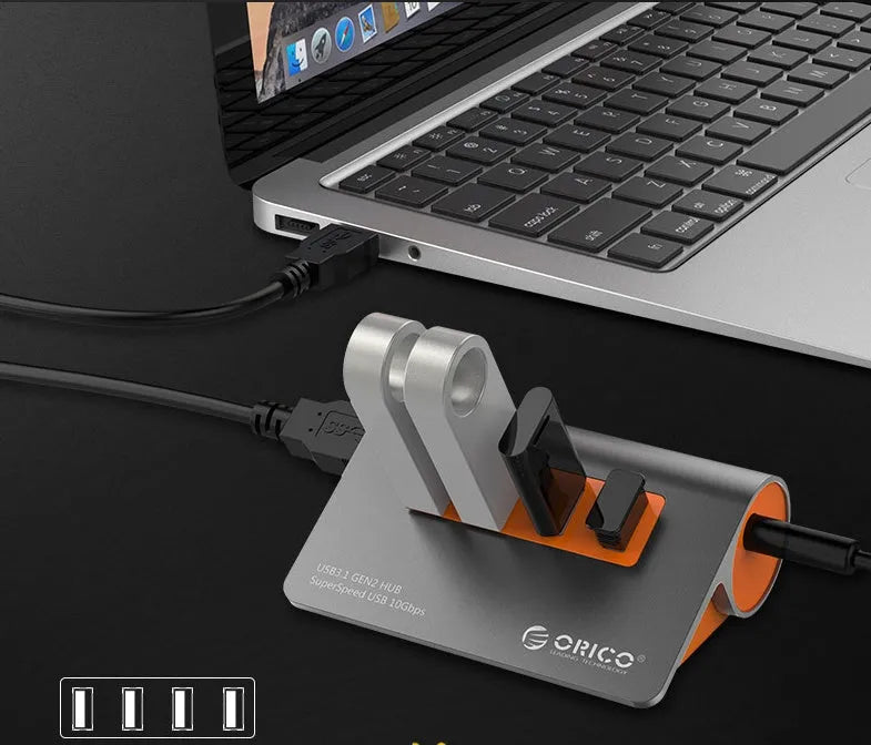 Dark grey and orange aluminium USB-C hub with four USB 3.1 ports and separate 100 cm cable