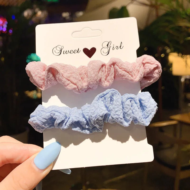 Set of 20 children's hair accessories including small intestine rings and large intestine ropes in assorted colours.
