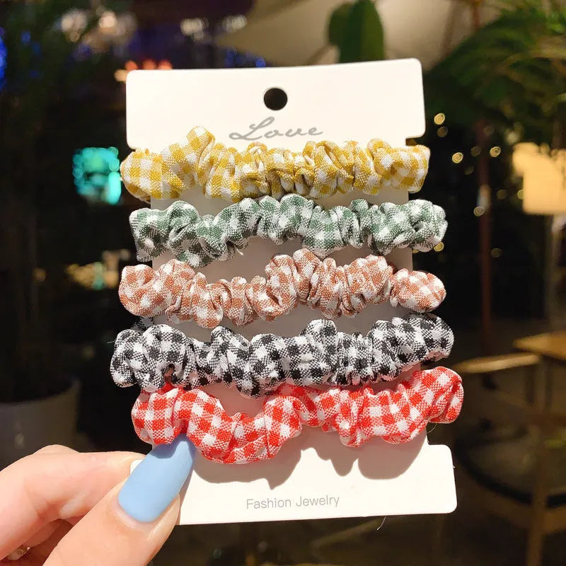 Set of 20 children's hair accessories including small intestine rings and large intestine ropes in assorted colours.