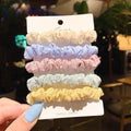 Set of 20 children's hair accessories including small intestine rings and large intestine ropes in assorted colours.