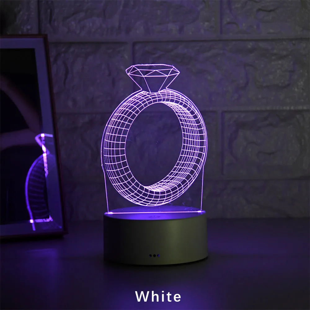 3D LED night light showing a glowing, laser-engraved diamond ring design on a black background.