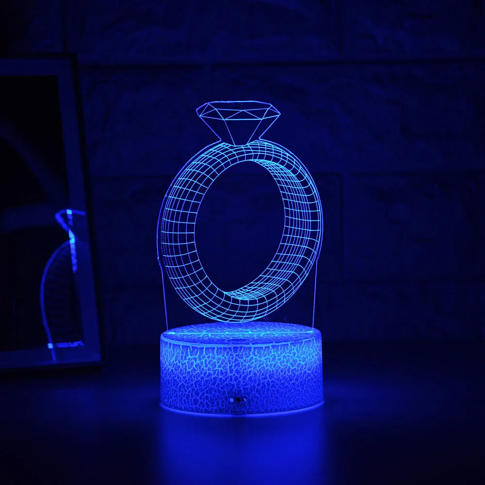 3D LED night light showing a glowing, laser-engraved diamond ring design on a black background.