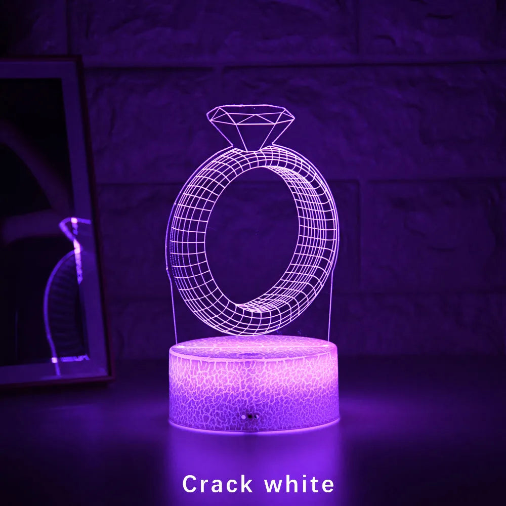 3D LED night light showing a glowing, laser-engraved diamond ring design on a black background.